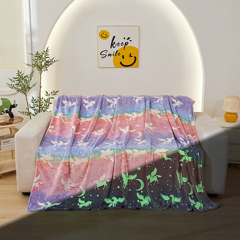 rainbow unicorn glow blanket on sofa day and night