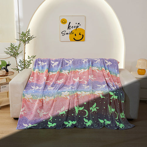 rainbow unicorn glow blanket on sofa day and night